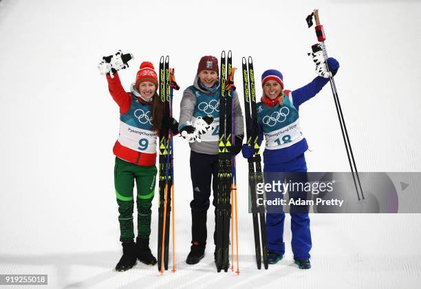 Silver medalist Darya Domracheva of Belarus, gold medalist Anastasiya Kuzmina of Slovakia and bronze medalist Tiril Eckhoff of Norway celebrate on...