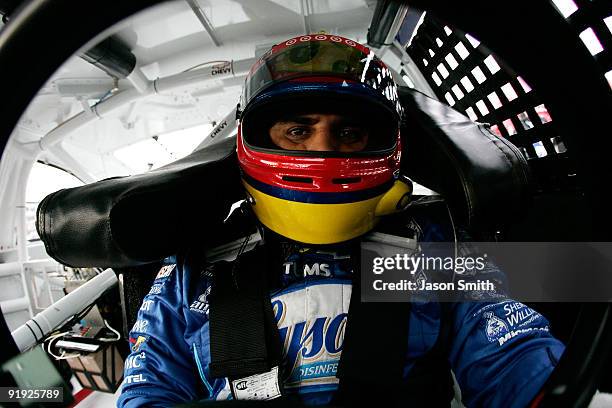 Juan Pablo Montoya, driver of the Lysol Chevrolet, sits in his car during practice for the NASCAR Sprint Cup Series NASCAR Banking 500 at Lowe's...