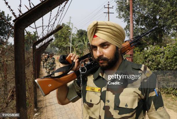 Indian Border Security Force personnel patrol along the India-Bangladesh border on the eve of Tripura state assembly elections in Lankamura village...