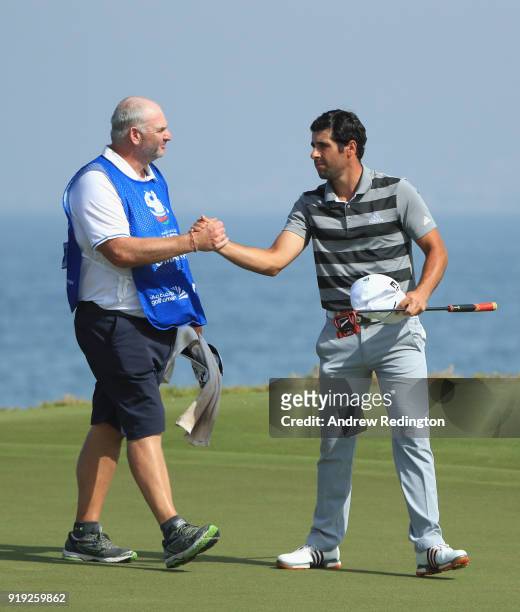 Adrian Otaegui of Spain shakes hands with is caddie on the 18th hole during the third round of the NBO Oman Open at Al Mouj Golf on February 17, 2018...