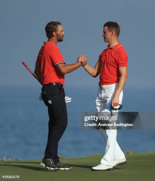 Joost Luiten and Daan Huizing shake hands on the 18th hole during the third round of the NBO Oman Open at Al Mouj Golf on February 17, 2018 in...