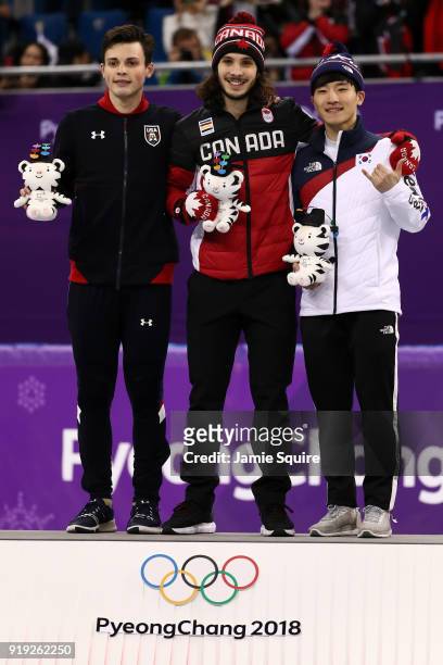 Silver medalist John-Henry Krueger of the United States, gold medalist Samuel Girard of Canada and bronze medalist Yira Seo of Korea celebrate during...