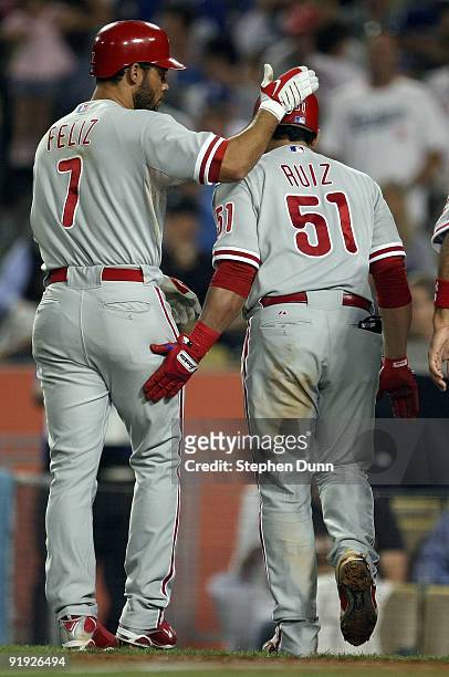Carlos Ruiz of the Philadelphia Phillies gets congratulated by teammate Pedro Feliz after, Ruiz, hit a three run home run in the fifth inning of Game...