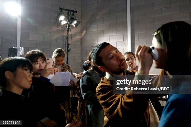 Model being styled backstage ahead of the Toga show during London Fashion Week February 2018 on February 17, 2018 in London, England.