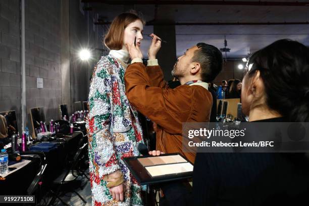 Model being styled backstage ahead of the Toga show during London Fashion Week February 2018 on February 17, 2018 in London, England.