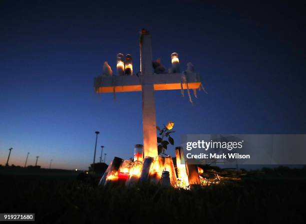 Candles glow at a memorial site to honor 17 people who were killed in the February 14 shooting at Marjory Stoneman Douglas High School, on February...