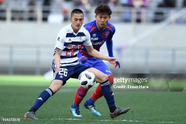 Ippei Shinozuka of Yokohama F.Marinos and Kosuke Ota of FC Tokyo compete for the ball during the preseason friendly match between FC Tokyo and...
