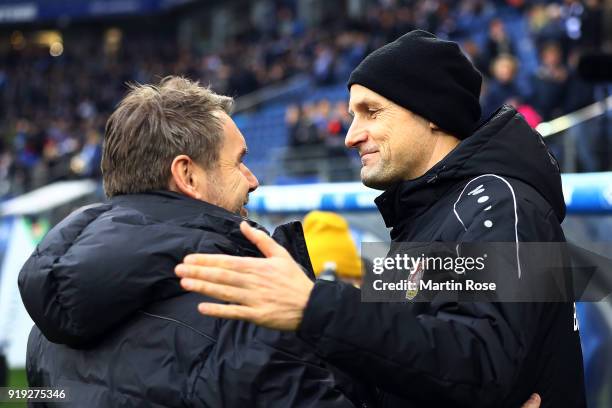 Bernd Hollerbach, coach of Hamburg, shakes hands with Heiko Herrlich, coach of Bayer Leverkusen, before the Bundesliga match between Hamburger SV and...