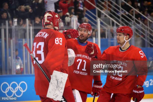 Vasili Koshechkin, Ilya Kovalchuk and Sergei Shirokov of Olympic Athlete from Russia celebrate after defeating the United States 4-0 during the Men's...