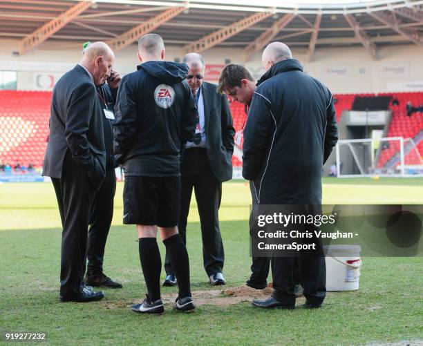 Member of the Doncaster Rovers ground staff repairs a hold in the Keepmoat Stadium pitch prior to the Sky Bet League One match between Doncaster...