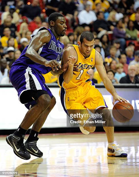 Jordan Farmar of the Los Angeles Lakers drives around Tyreke Evans of the Sacramento Kings during their preseason game at the Thomas & Mack Center...