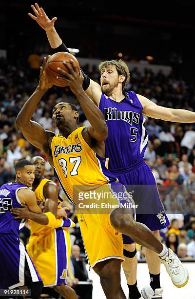 Ron Artest of the Los Angeles Lakers drives against Andres Nocioni of the Sacramento Kings during their preseason game at the Thomas & Mack Center...