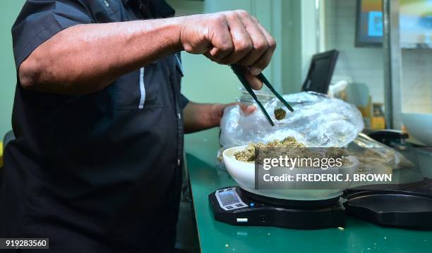 Marijuana is weighed on a scale at Virgil Grant's dispensary in Los Angeles, California on February 8, 2018. Virgil Grant is riding the high on...