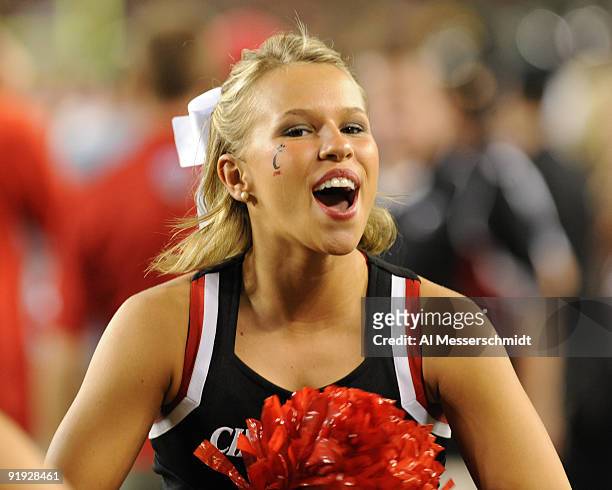Cheerleader for the Cincinnati Bearcats watches play against the University of South Florida Bulls October 15, 2009 at Raymond James Stadium in...