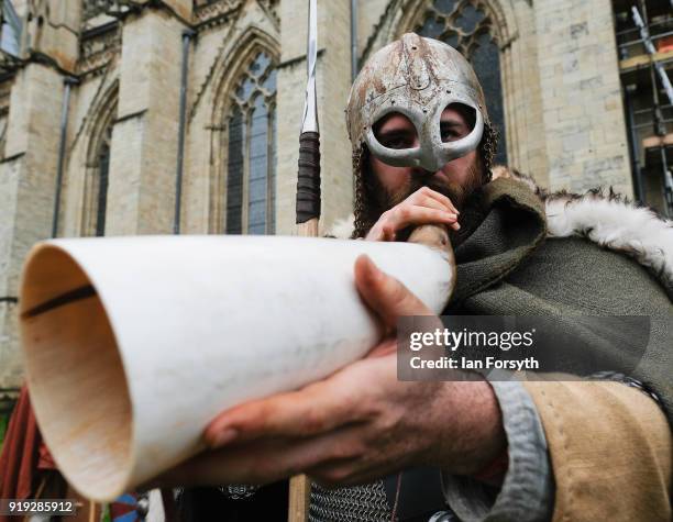 Re-enactor blows his horn in a call to arms as he joins other re-enactors representing the rival armies of the Vikings and Anglo-Saxons as they...