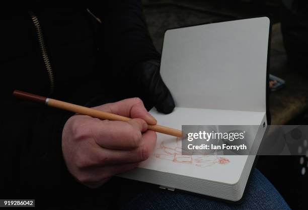 An artist sketches as re-enactors representing the rival armies of the Vikings and Anglo-Saxons prepare to march through York City during the Jorvik...