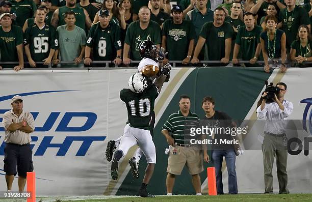 Defensive back Jerome Murphy of the South Florida Bulls deflects a pass intended for receiver Armon Binns of the Cincinnati Bearcats during the game...