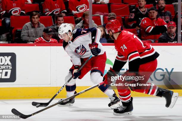 Josh Anderson of the Columbus Blue Jackets carries the puck past the the defense of Jaccob Salvin of the Carolina Hurricanes during an NHL game on...