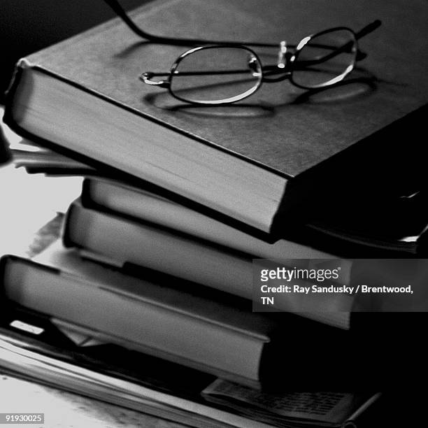 book stack with reading glasses! - brentwood tennessee stock pictures, royalty-free photos & images