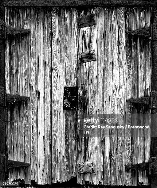old wooden factory doors in b&w - brentwood tennessee stock pictures, royalty-free photos & images