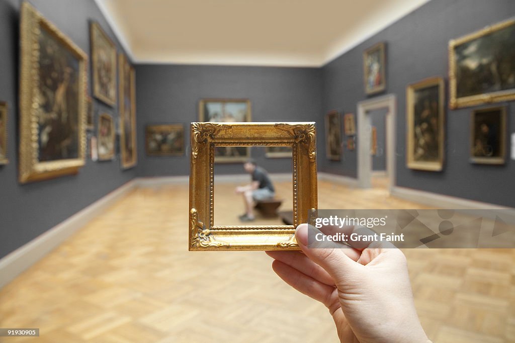 Blurry young man framed by small golden frame