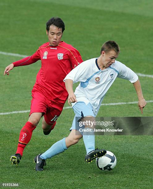 Sam Munro of Sydney shields the ball from Inseab Shin of United during the round six National Youth League match between Adelaide United and Sydney...