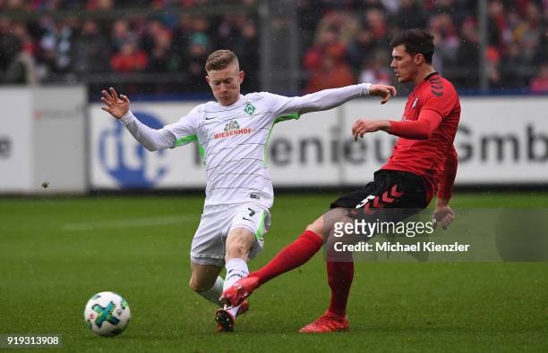 Pascal Stenzel of SC Freiburg challenges Florian Kainz of SV Werder Bremen during the Bundesliga match between Sport-Club Freiburg and SV Werder...