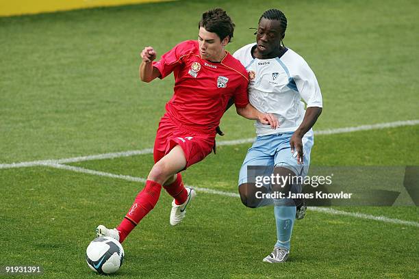 Joel Allwright of United is tackled by Kofi Danning of Sydney during the round six National Youth League match between Adelaide United and Sydney FC...