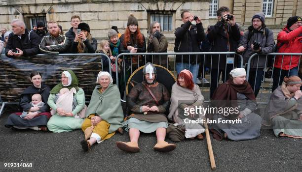 Members of the public and re-enactors look on as re-enactors representing the rival armies of the Vikings and Anglo-Saxons skirmish in York during...