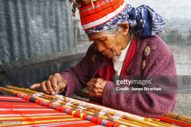ifugao (ancient culture of wet-rice agriculturalists) woman weaver in traditional dress and hat, banaue, luzon island, philippines (model release) - philippines stock pictures, royalty-free photos & images