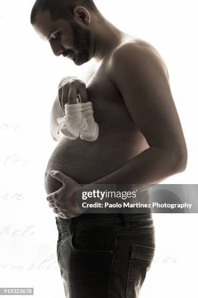 pregnant man standing - biella stock pictures, royalty-free photos & images