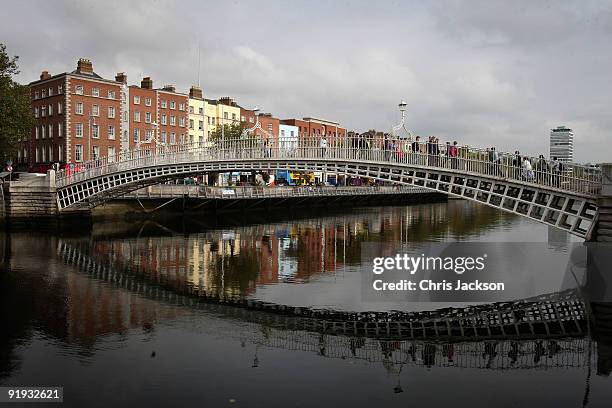 People walk over over Ha'penny Bridge on October 15, 2009 in Dublin, Ireland. Dublin is Ireland's capital city, located near the midpoint of...