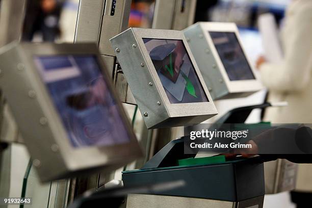 Woman puts her passport into a reader during the presentation of the new automated border control system easyPass at Frankfurt International Airport...