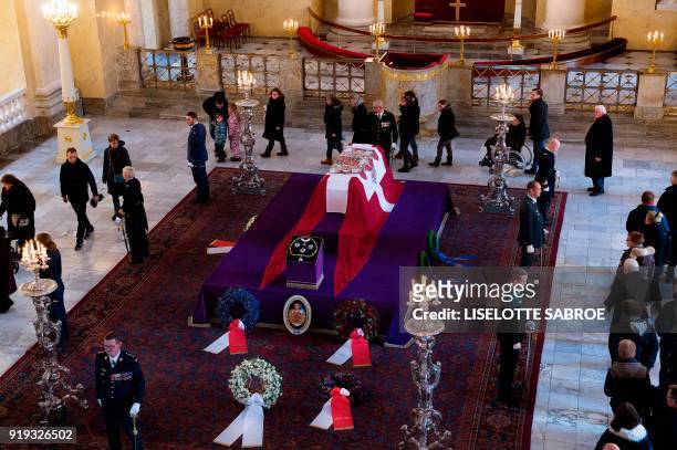 People line up inside Christiansborg Palace Church to see the coffin of late Price Henrik n Castrum Doloris in Copenhagen on February 17, 2018. - The...