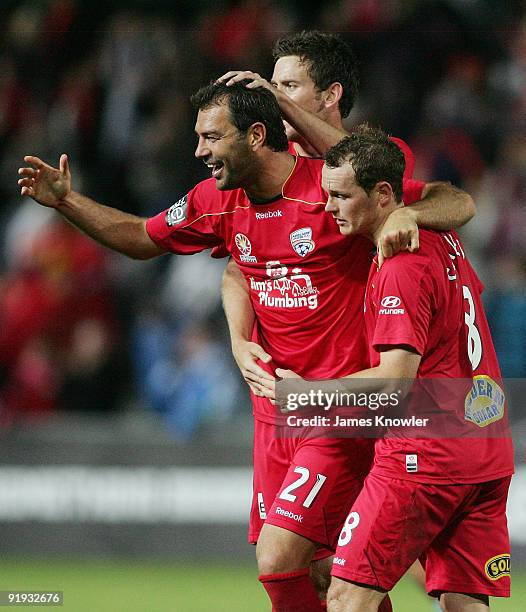 Mark Rudan, Robert Cornthwaite and Kristian Sarkies of United celebrate after the round 11 A-League match between Adelaide United and Sydney FC at...