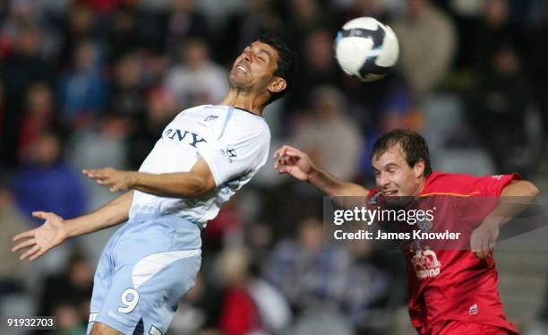 John Aloisi of Sydney attempts to head the ball over Iain Fyfe of United during the round 11 A-League match between Adelaide United and Sydney FC at...