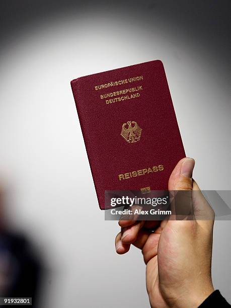 Man holds up a passport with the EasyPass sign at the bottom during the presentation of the new automated border control system easyPass at Frankfurt...