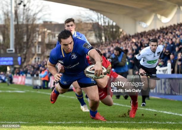 Dublin , Ireland - 17 February 2018; James Lowe of Leinster goes over to score his side's first try despite the tackle of Corey Baldwin of Scarlets...