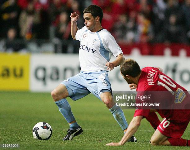 Stuart Musialik of Sydney is tackled by Adam Hughes of United during the round 11 A-League match between Adelaide United and Sydney FC at Hindmarsh...