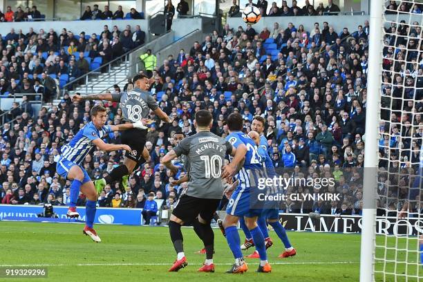 Coventry City's English striker Jonson Clarke-Harris misses with this header during the English FA Cup fifth round football match between Brighton...