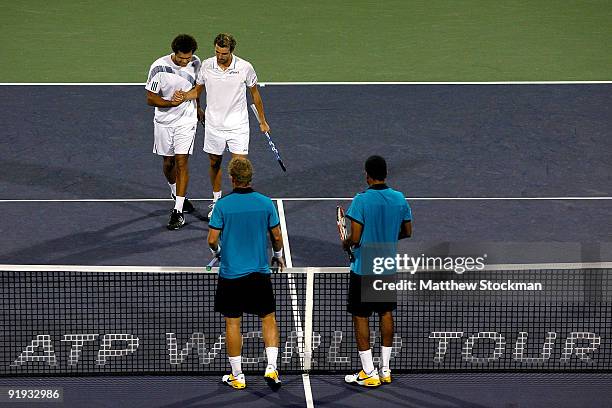 Julien Benneteau of France and Jo-Wilfried Tsonga celebrate match point against Marknowles of the Bahamas and Mahesh Bhupathi of India during day six...