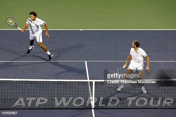 Jo-Wilfried Tsonga returns a shot to Mahesh Bhupathi of India and Mark Knowles of the Bahamas while playing with Julien Benneteau of France during...