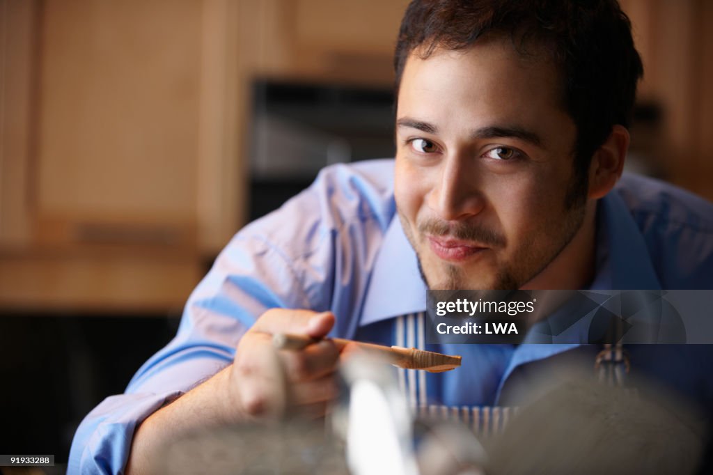 Man Tasting Sauce, In Kitchen