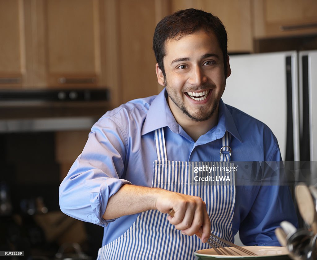 Happy Man Cooking In Kitchen