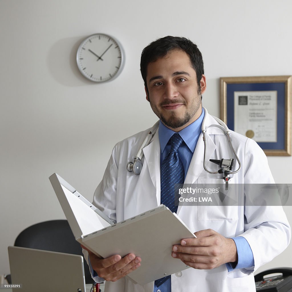 Doctor Holding Charts, In Office