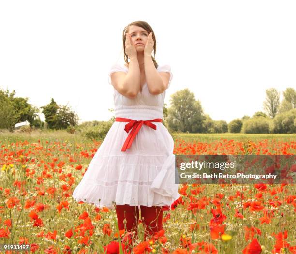 a portrait of a girl with field of poppies - stehmohn stock-fotos und bilder