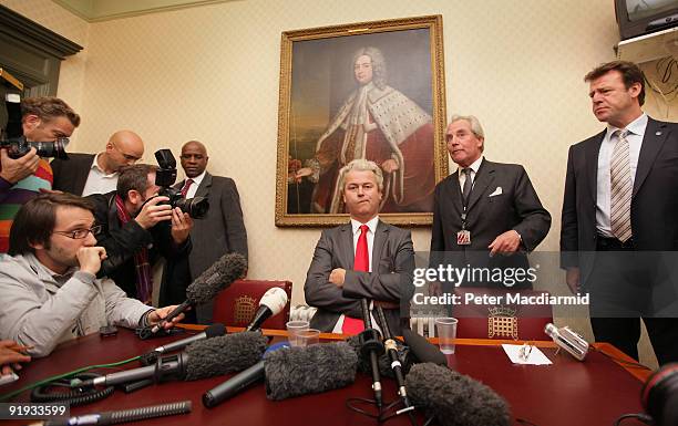 Right-wing Dutch MP Geert Wilders is watched by Lord Pearson and a security official as he speaks to reporters near Parliament on October 16, 2009 in...