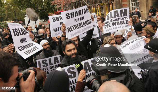 Protestors hold placards outside a press conference being held by right-wing Dutch MP Geert Wilders on October 16, 2009 in London. Mr Wilders was...