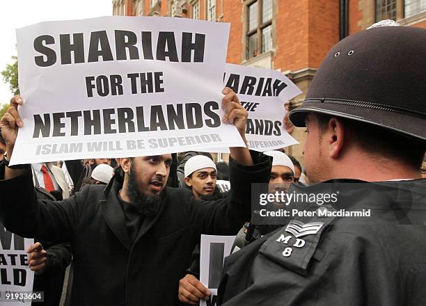 Protestors hold placards outside a press conference being held by right-wing Dutch MP Geert Wilders on October 16, 2009 in London. Mr Wilders was...