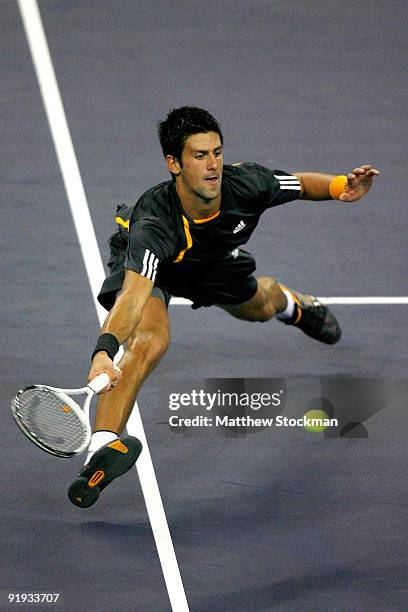 Novak Djokovic of Serbia stretches for a ball against Gilles Simon of France during day six of the 2009 Shanghai ATP Masters 1000 at Qi Zhong Tennis...